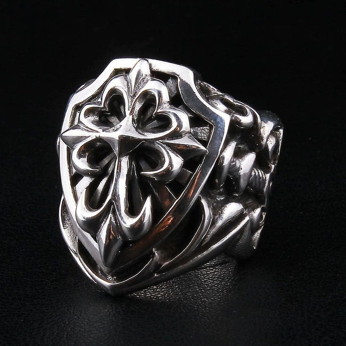 Right angle view of heavy sterling silver shield ring with fleur-de-lis cross pattern