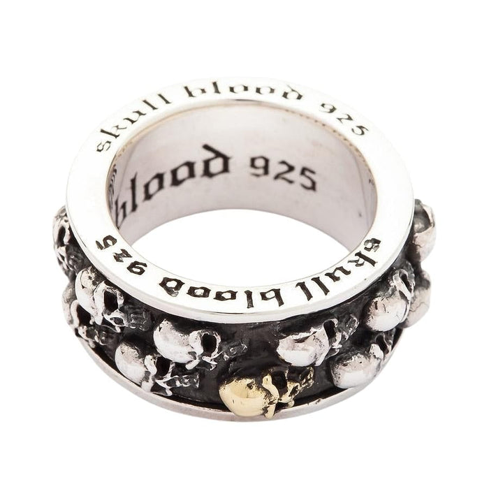 The gothic fidget ring for men, shown from the side to highlight its 14mm width and the multiple skulls on the band.
