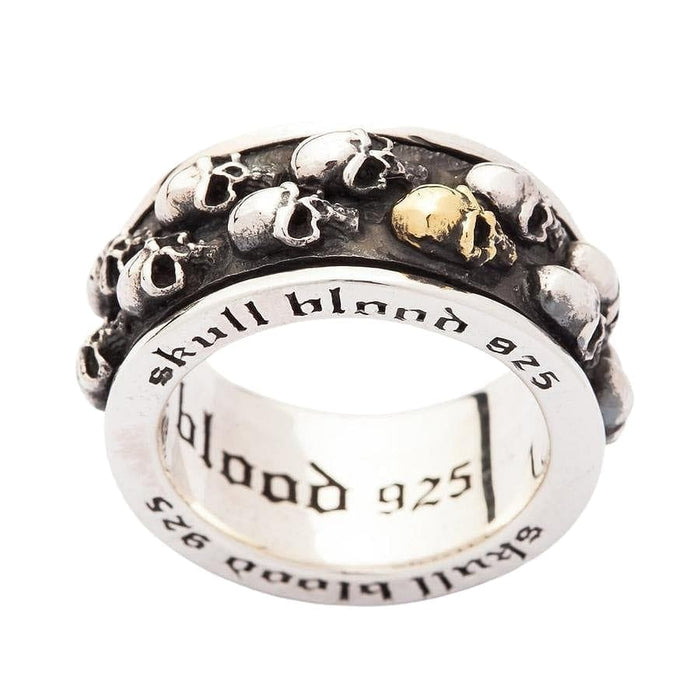 A close-up, angled view of the biker skull anxiety ring, focusing on the gold-plated skull and oxidized details.