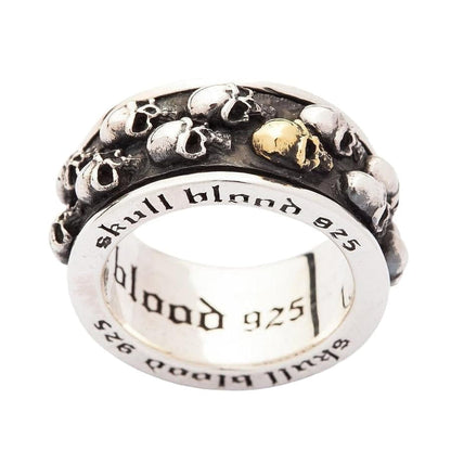 A close-up, angled view of the biker skull anxiety ring, focusing on the gold-plated skull and oxidized details.