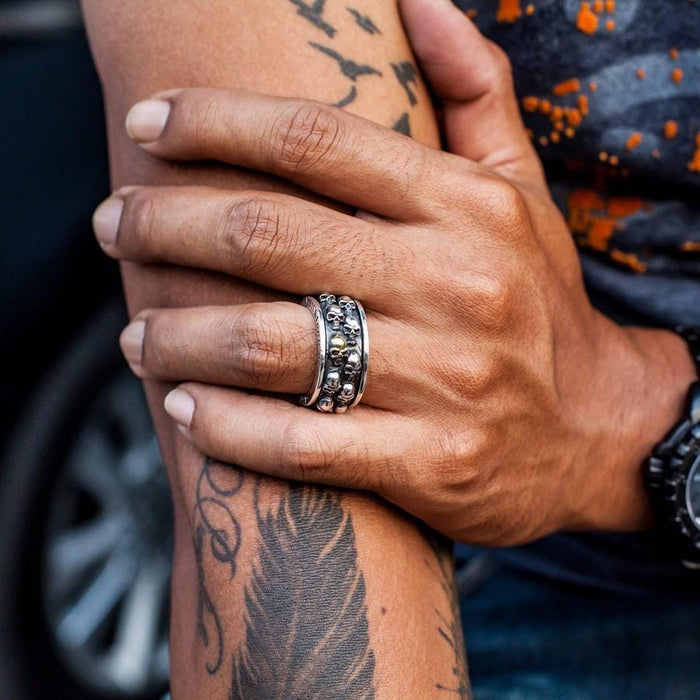 A handcrafted biker spinner ring being worn, demonstrating its substantial size and comfortable fit.
