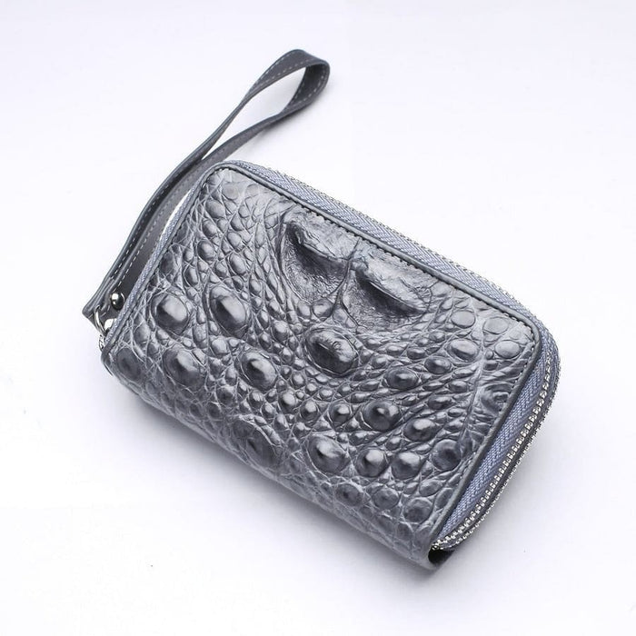 Gray crocodile skin wristlet wallet angled view with detachable strap