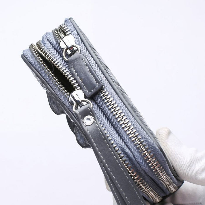 Top view of dual zipper gray crocodile leather wallet