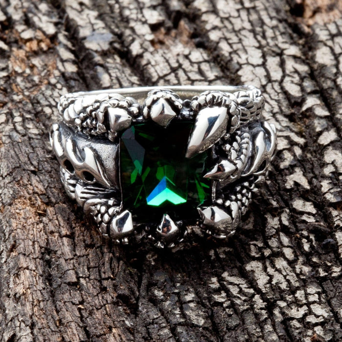 A front view of the green claw gothic ring in sterling silver, showing the emerald CZ stone held by dragon talons.