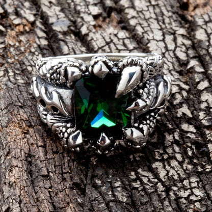 A front view of the green claw gothic ring in sterling silver, showing the emerald CZ stone held by dragon talons.