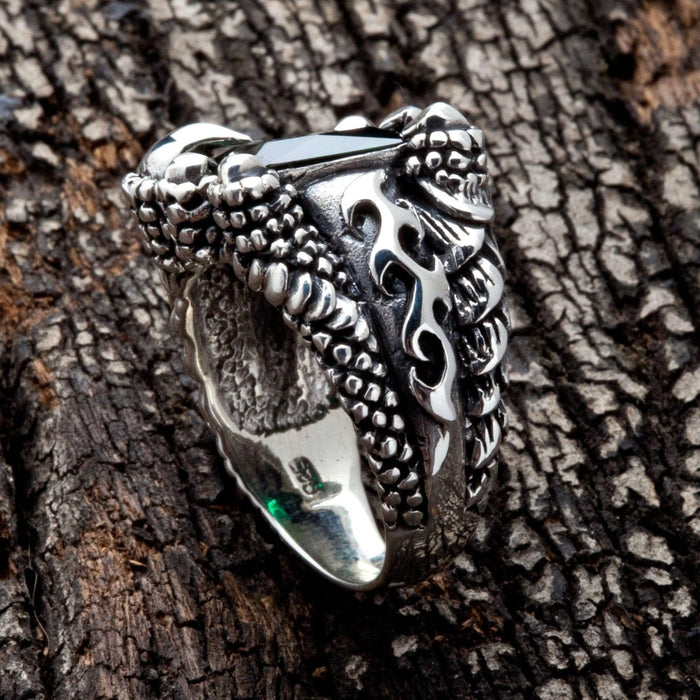 Side view of the green dragon claw ring showing pierced flame cutwork on the scaled sterling silver band.