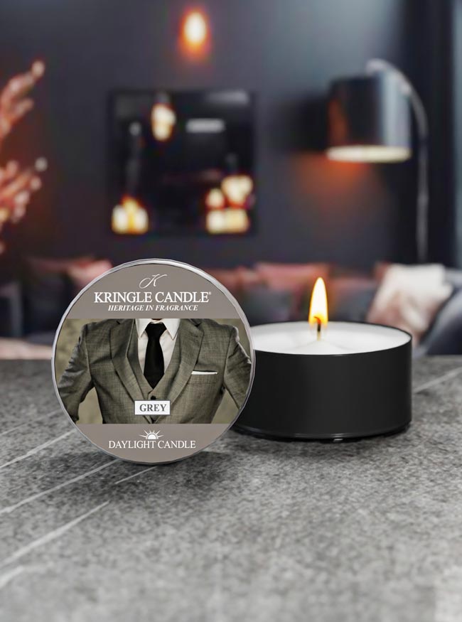 Kringle Candle daylight candle with a label featuring a suit on a gray surface.