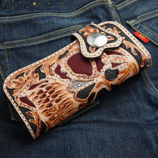 A premium hand-tooled leather skull wallet with a fiery red stingray inlay and intricate traditional floral patterns.