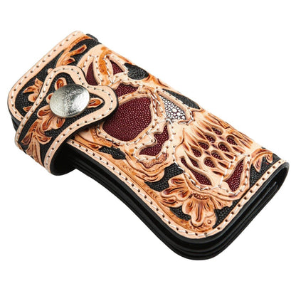 A premium, custom leather wallet with a detailed skull design, traditional floral tooling, and a solid silver concho snap.