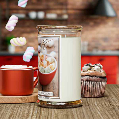 Candle jar with marshmallow design, red mug, and cupcake on a wooden surface.