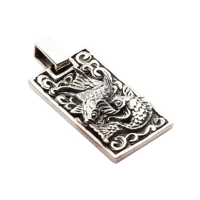 Side angle of 925 silver Koi fish pendant showing depth of carving and swirling wave motif