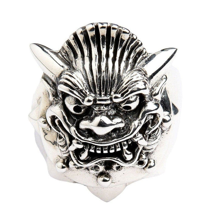 Detailed close-up of Hannya mask ring face showing curved horns, fang-baring snarl, and deep oxidized grooves in .925 sterling silver
