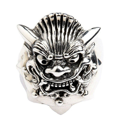 Detailed close-up of Hannya mask ring face showing curved horns, fang-baring snarl, and deep oxidized grooves in .925 sterling silver