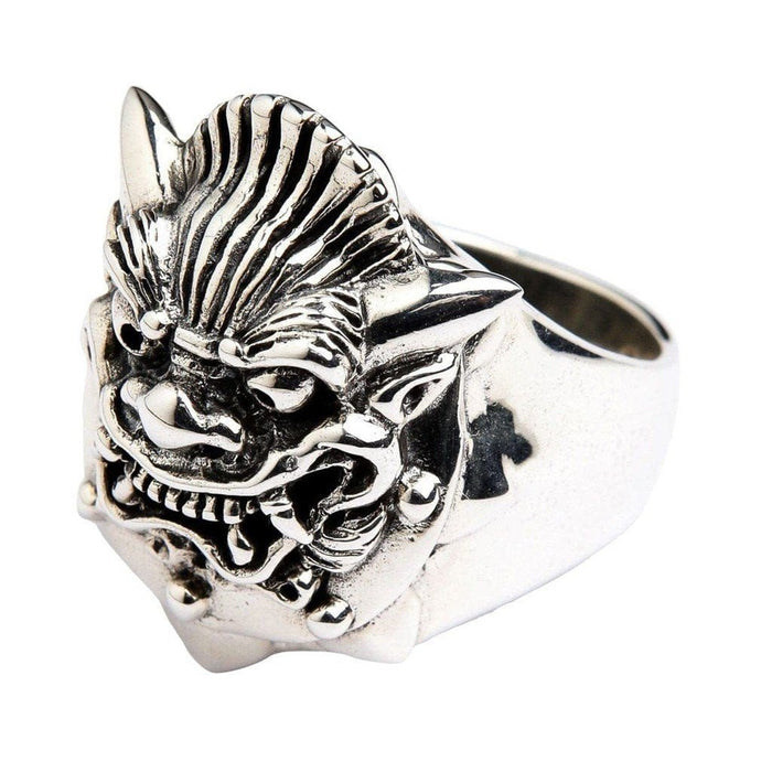 Three-quarter view of heavy sterling silver Hannya ring showing ridged forehead texture, pointed horns, and cross cutout on band shank