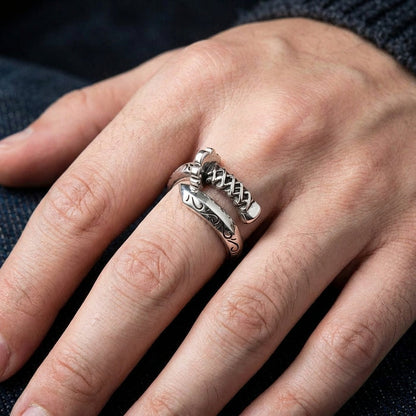 A man's hand wearing the 15mm wide sterling silver samurai katana ring.