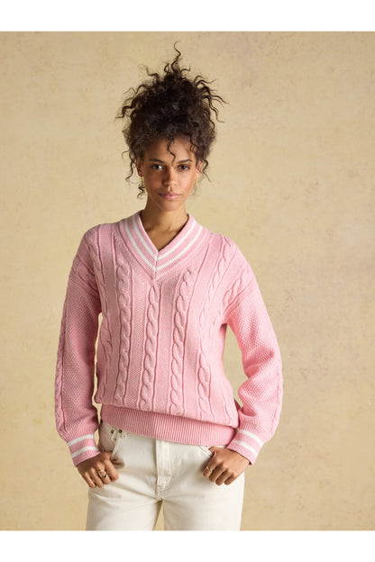 Model wearing Joules W25282 Dibly Cable Knit Jumper – Pink featuring cable knit pattern and striped V-neck by Joules. Shop Joules at Dotique.