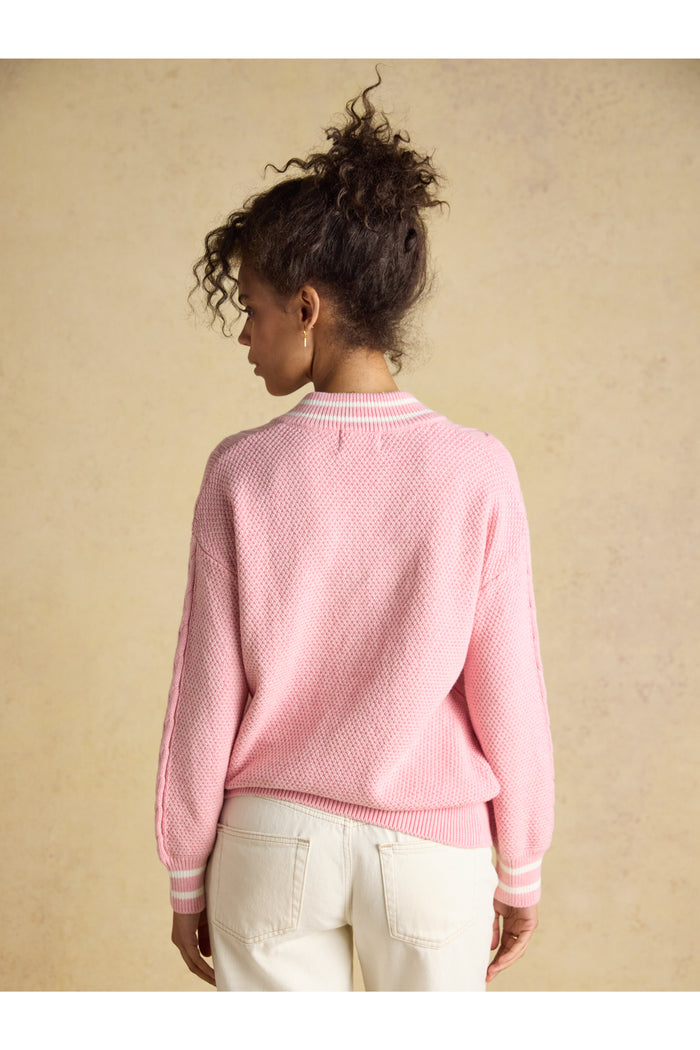 Model showing back view of Joules W25282 Dibly Cable Knit Jumper – Pink with textured knit and striped cuffs by Joules. Shop Joules at Dotique.