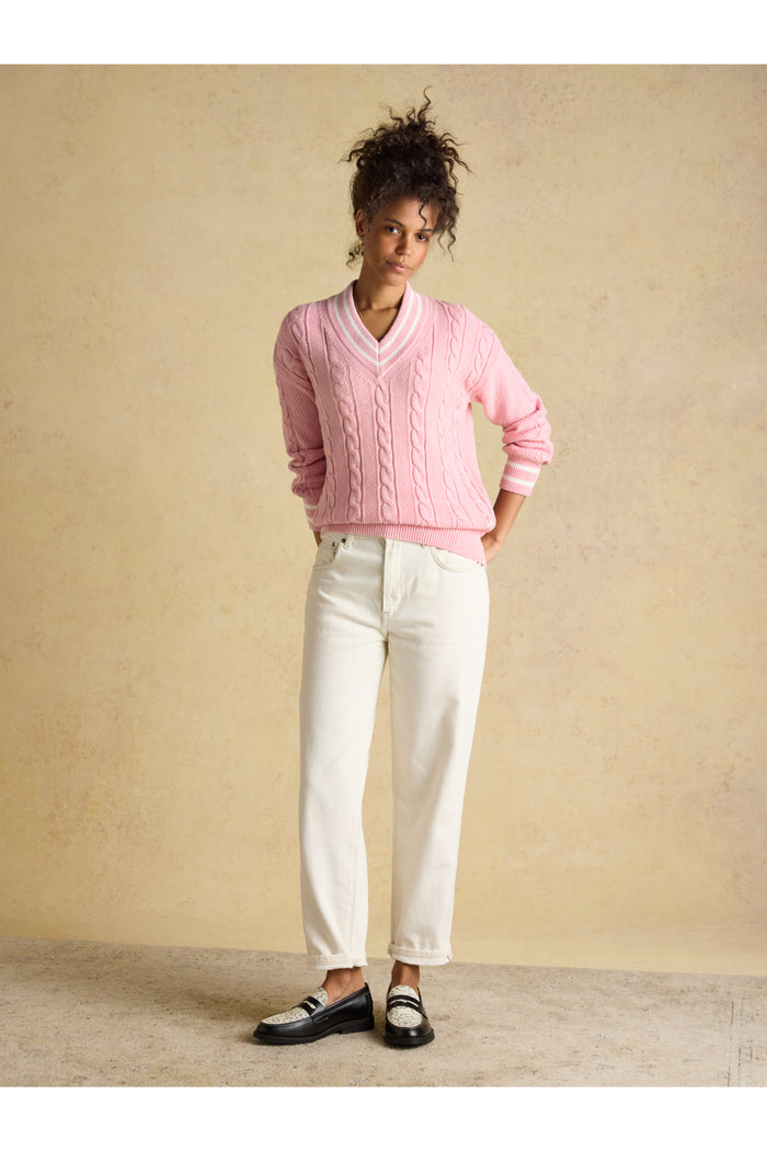 Model wearing Joules W25282 Dibly Cable Knit Jumper – Pink with white trousers and black loafers by Joules. Shop Joules at Dotique.