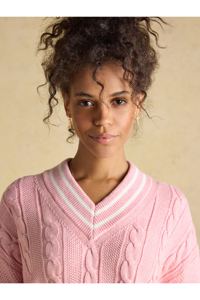 Close-up of model wearing Joules W25282 Dibly Cable Knit Jumper – Pink with V-neck and striped collar by Joules. Shop Joules at Dotique.