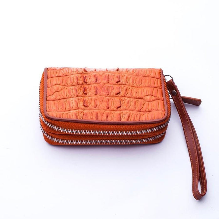 Angled view of double zipper brown leather wallet showing compact design