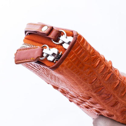 Close-up detail of durable zipper hardware on the crocodile leather wallet