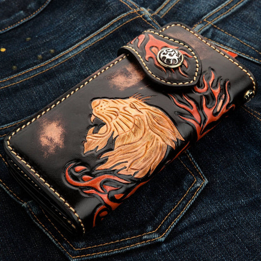 Front view of black leather biker wallet featuring a hand-carved roaring lion and red flame design.