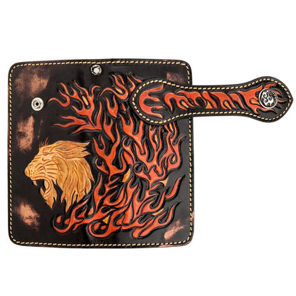 Close-up of the wallet's spine featuring intricate hand-carved orange and black flame designs on genuine cowhide leather.