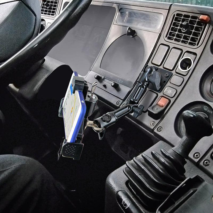The LockVise™ Locking Phone Mount with 4-Hole AMPS Drill Base secures a smartphone running a navigation app inside a vehicle, with the steering wheel, dashboard controls, gear shift, and vents visible in the cockpit.