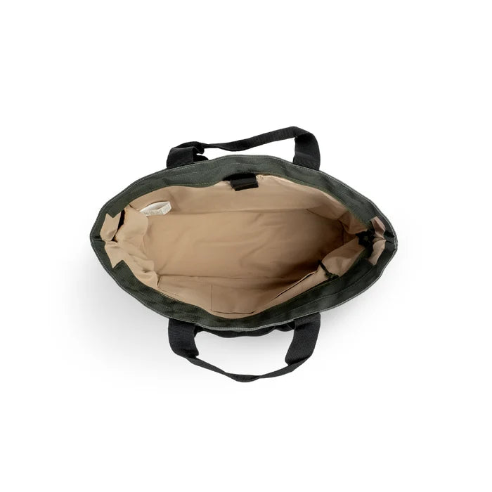 Luxe Tote bag overhead view of a dark green canvas tote bag showing its beige interior lining and black handles, set against a plain white background.