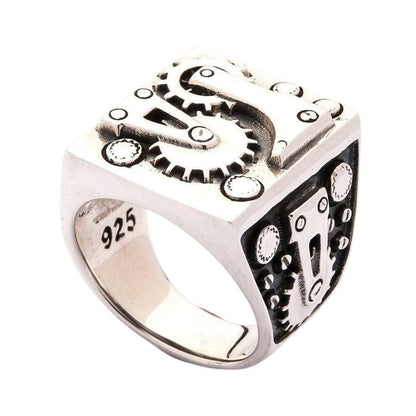A handcrafted mechanical biker ring showing the oxidized background and polished gears.