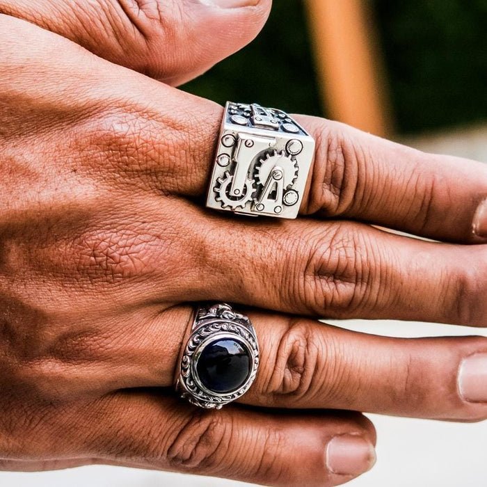A statement piece of biker jewelry, the mechanical gear ring, on a white background.
