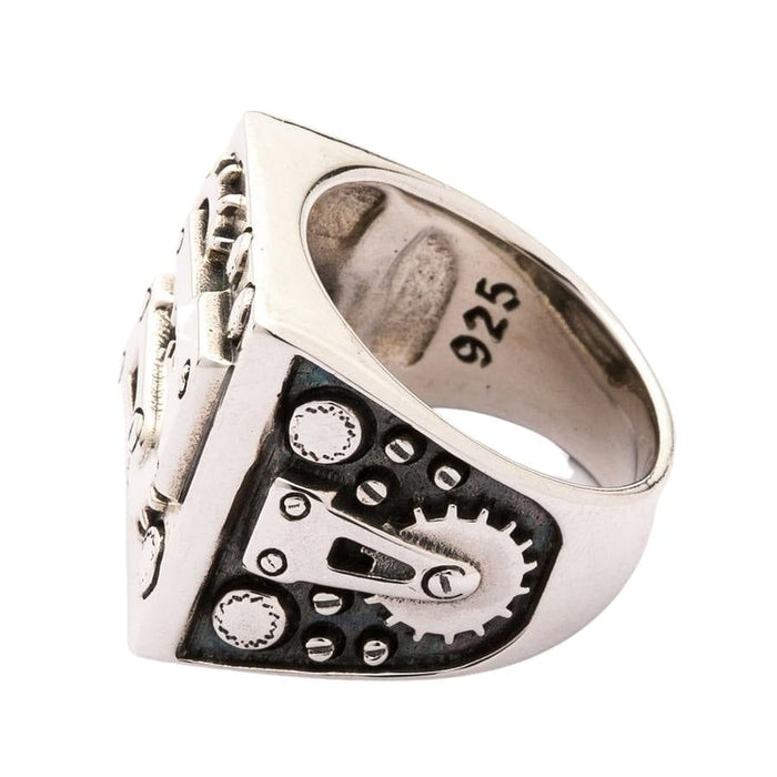 Raised gear and screws stand on an oxidized side panel, with the 925 stamp readable inside the band.
