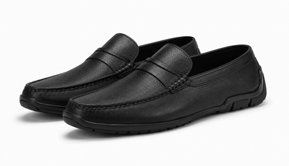 Pair of black leather loafers on a white background
