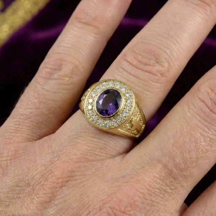 Amethyst clergy ring worn on hand showing violet gemstone with diamond halo and gold cross details