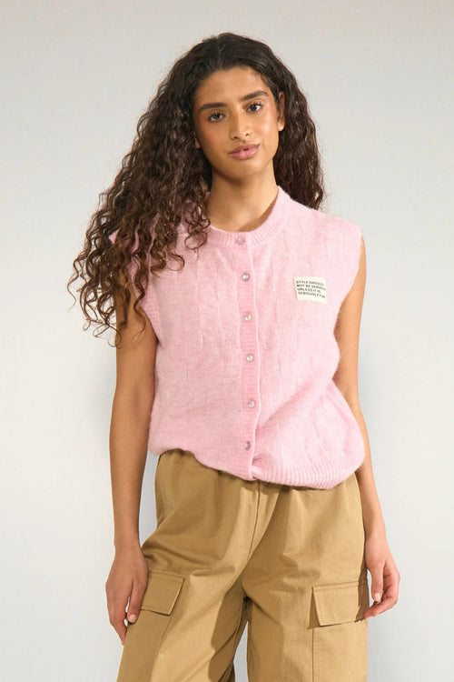 Model wearing Numph 706928 NURIETTE CHECK VEST – Pink Lady sleeveless button-up vest in soft pink by Numph. Shop Numph at Dotique.