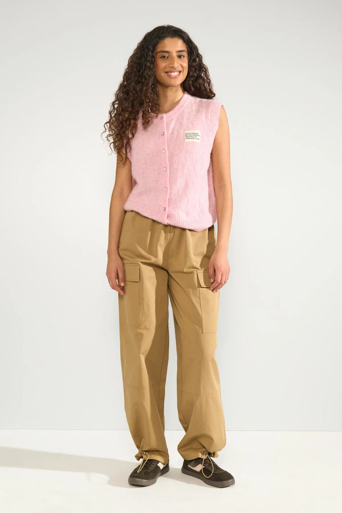 Model wearing Numph 706928 NURIETTE CHECK VEST – Pink Lady sleeveless pink knit vest with front buttons by Numph. Shop Numph at Dotique.