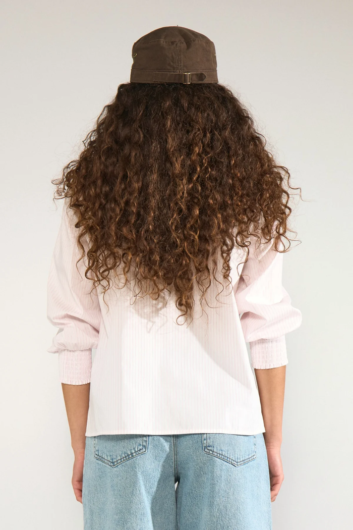 Back view of model wearing Numph 707070 Nulili Blouse Pink Lady with subtle stripes and smocked cuffs by Numph. Shop Numph at Dotique.