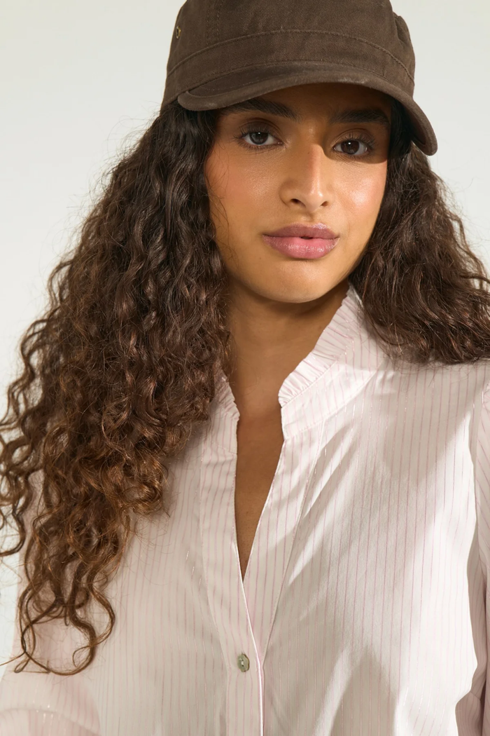 Close-up of a woman wearing Numph 707070 Nulili Blouse Pink Lady with delicate pink stripes and a soft collar by Numph. Shop Numph at Dotique.