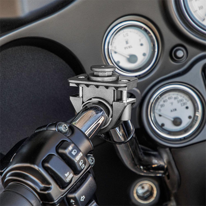 Close-up of the OCTO™ Series Motorcycle or Bicycle Handlebar Mount securely attached to a handlebar; dashboard gauges and control buttons appear in the background, ensuring compatibility with octagon pattern accessories.