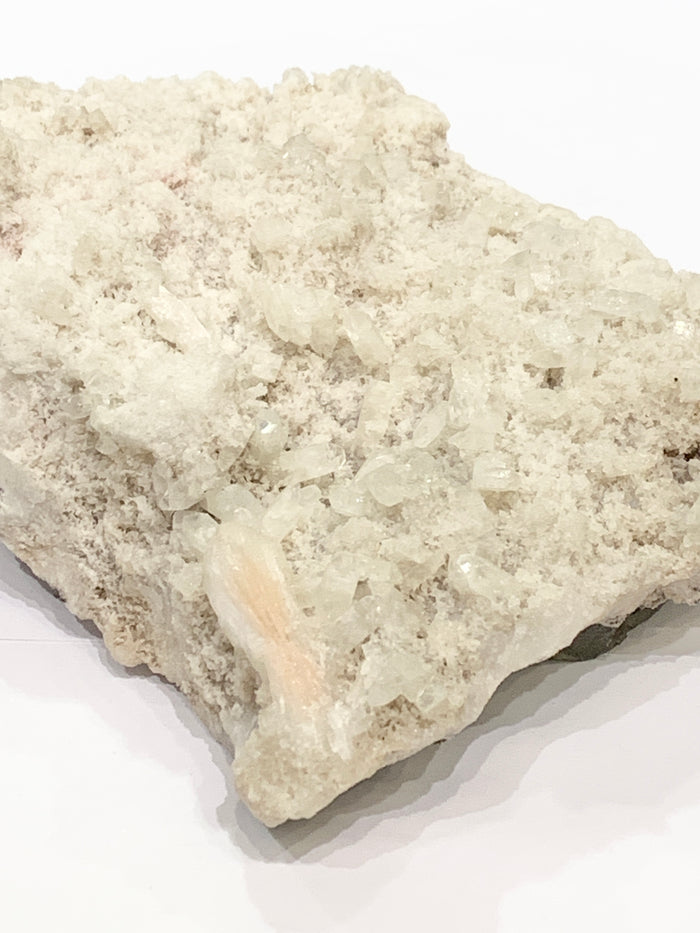 #2 Peach Stilbite with druzzy Apophyllite on a white background, front view.