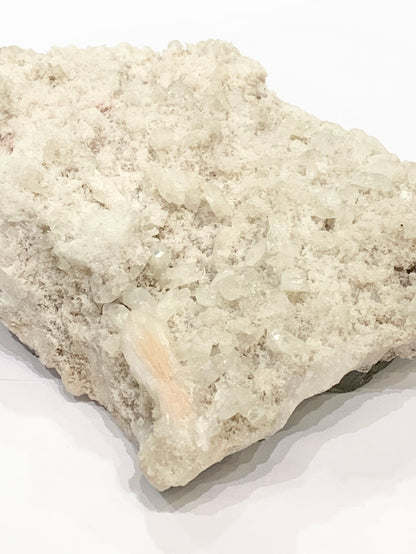 #2 Peach Stilbite with druzzy Apophyllite on a white background, front view.