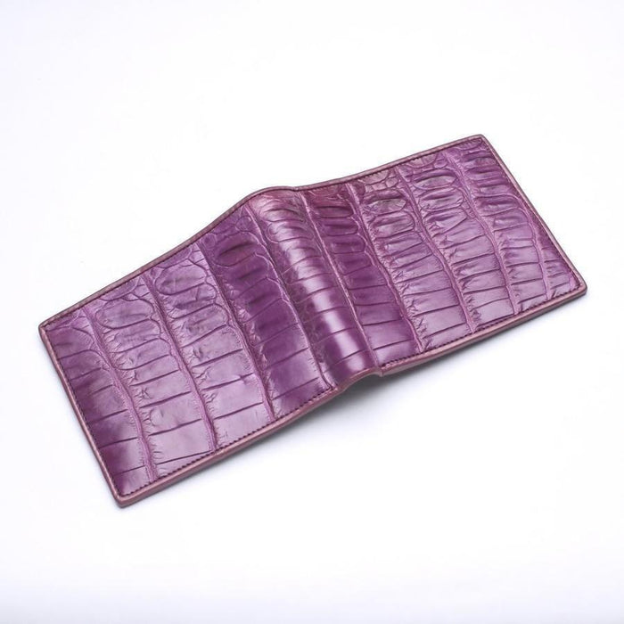 Spread-open view of the bifold exterior, showcasing the continuous deep-purple dyed crocodile leather scales.