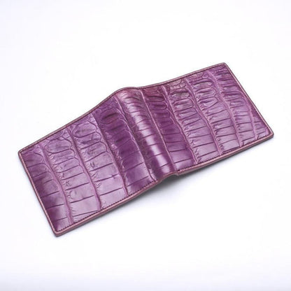 Spread-open view of the bifold exterior, showcasing the continuous deep-purple dyed crocodile leather scales.