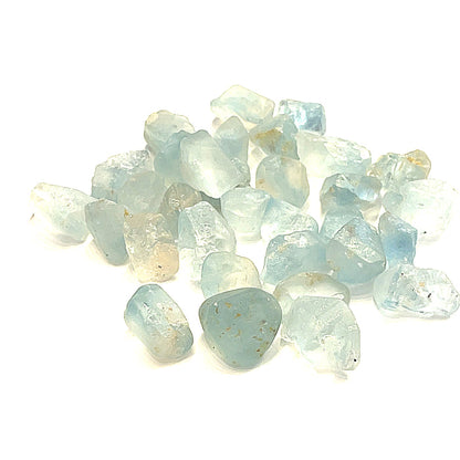 Raw Blue Topaz Gemstone on white grouping center  overview