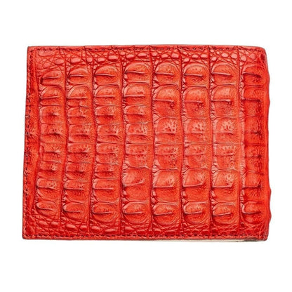 Large glossy crocodile scales cover the red wallet, stitching closing the top, bottom and left edges.