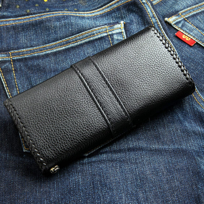 Vertical strap runs down the pebbled back, braided stitching at the edges and a chain loop at the corner.
