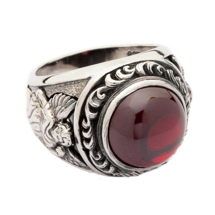 A side profile of the silver ring, showing the detailed engraving of a Cupid or angel with wings.