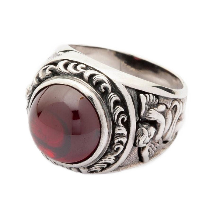 An angled view of the men's gothic red stone ring with cupid engravings.