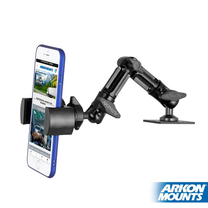 The black RoadVise Heavy-Duty Multi-Angle Phone Mount from Arkon Mounts securely holds a smartphone with a blue case. It features a 4-Hole AMPS base for flat surface attachment and displays the Arkon logo in the bottom right corner.