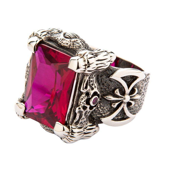 A large sterling silver dragon claw ring holding a massive rectangular ruby-red stone on a white background.